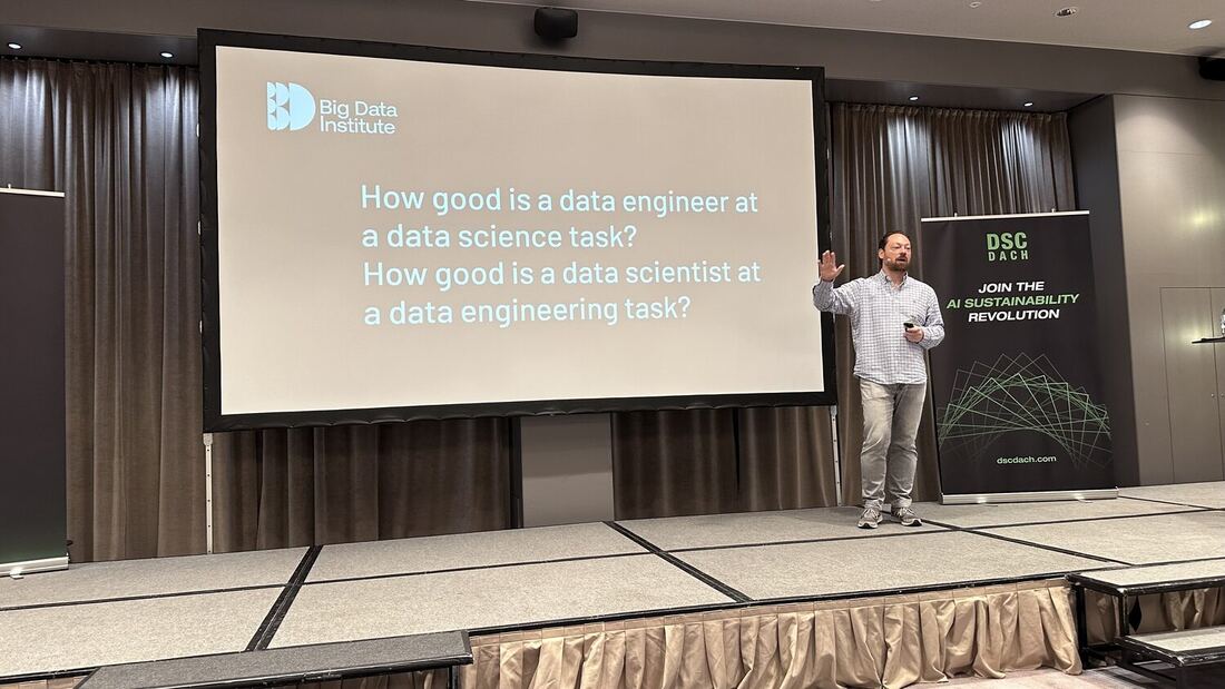 A speaker beside a Big Data Institute slide asking how good a data engineer is at a data science task, and how good a data scientist is at a data engineering task.