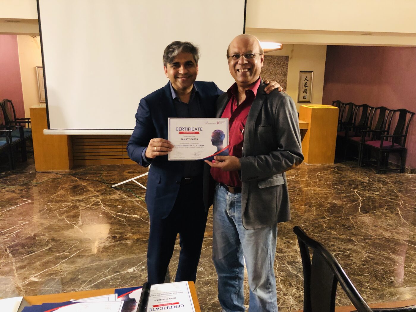 Tarry Singh hands a certificate of participation to a participant at the close of the Business Executive to AI Leader workshop; the certificate carries the Analytics Vidhya and DataHack Summit 2018 marks.