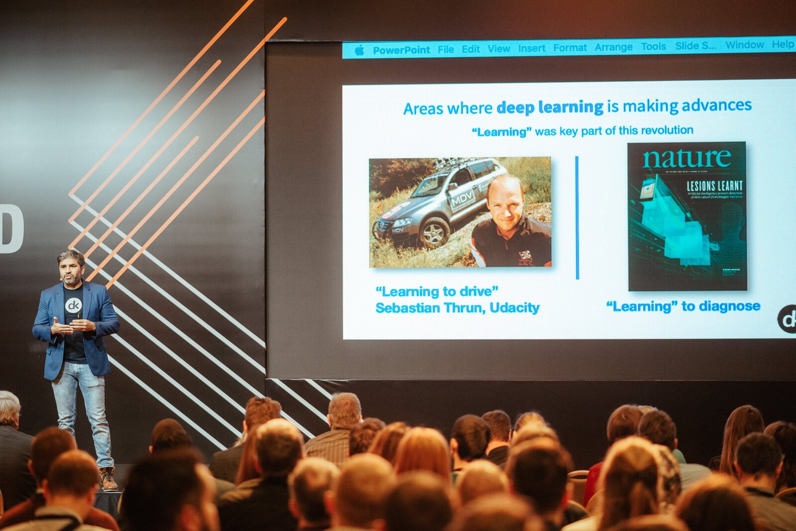The talk in progress: a slide headed "Areas where deep learning is making advances", carrying Sebastian Thrun on learning to drive alongside a Nature cover on learning to diagnose, with the audience seated below.
