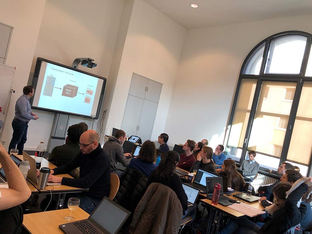 Participants with laptops following the capsule networks lecture