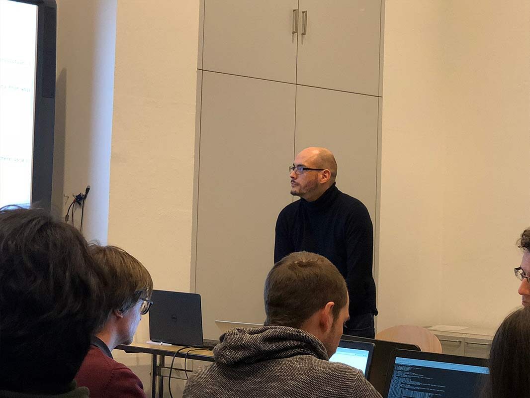 Lecturer addressing the workshop room in Berlin