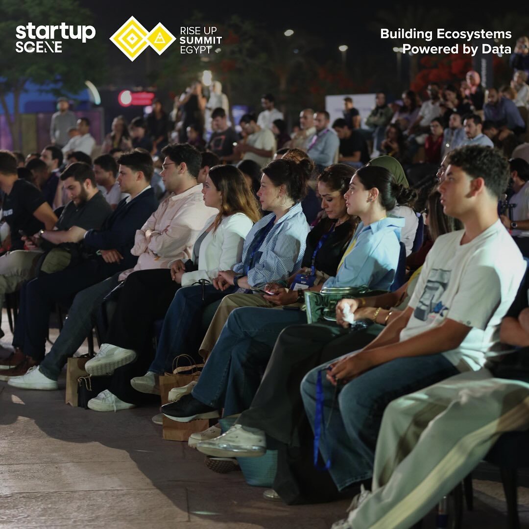 Packed rows of seated delegates watching the summit panel session