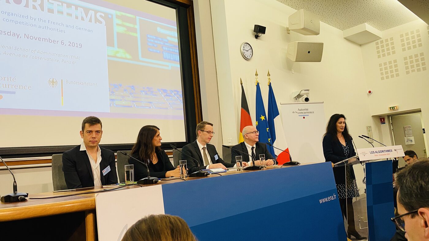A speaker at the lectern bearing the Les Algorithmes card, four panellists seated at the ENA table, and the title slide giving the date of 6 November 2019 and the two organising authorities.