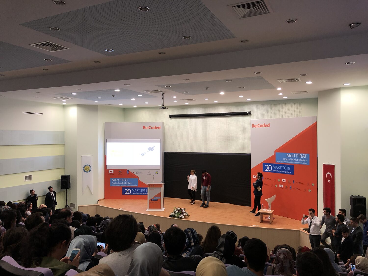 Presenters on the Harran University stage taking the hall through their projects