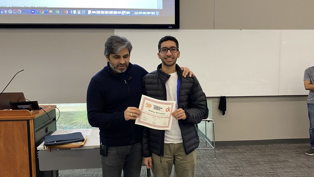 A participant receives the certificate of completion at the front of the hall on the closing day.