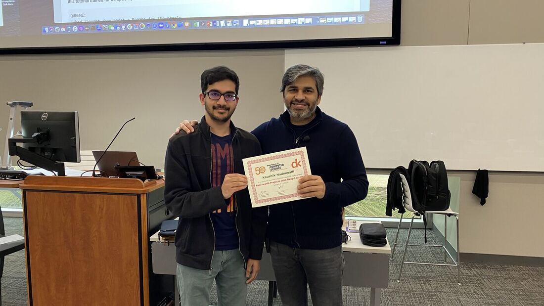 A participant receives the certificate of completion at the front of the hall on the closing day.