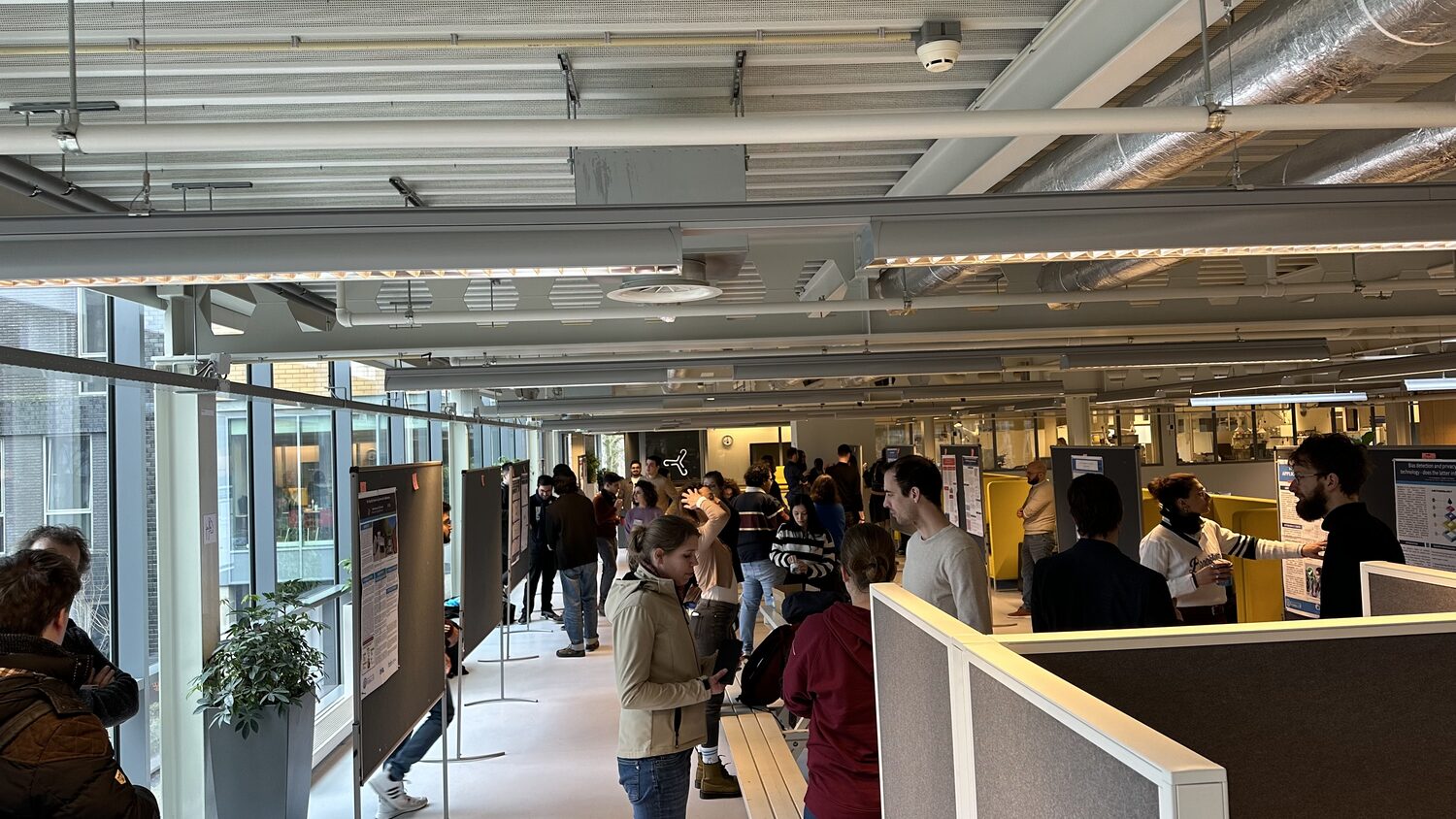Delegates move between poster boards on an open study floor during the poster session at Utrecht Science Park, 2 February 2024.